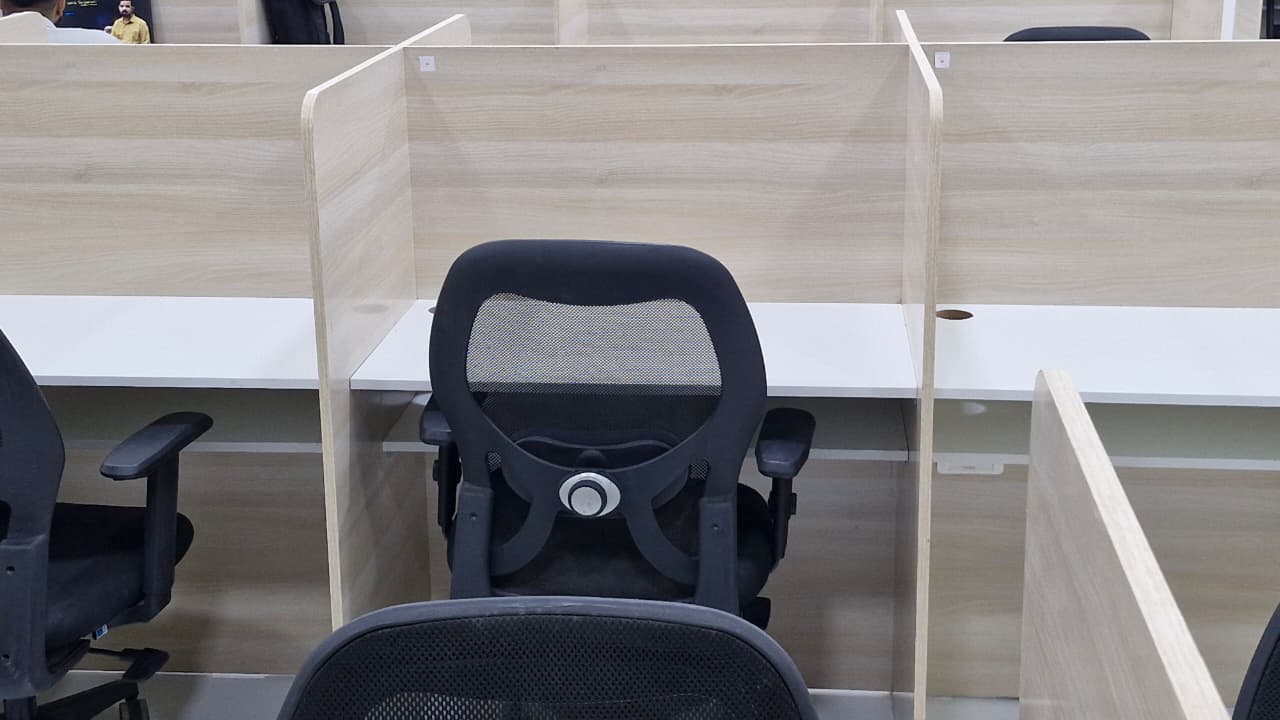 Individual ergonomic study desk with high-back mesh chair and acoustic privacy partitions at Restart Reading Room